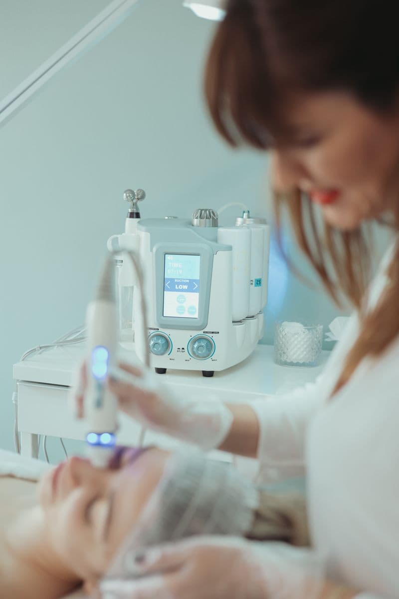 Close-up of HydraFacial treatment device applied to skin in modern beauty clinic — aftercare tips
