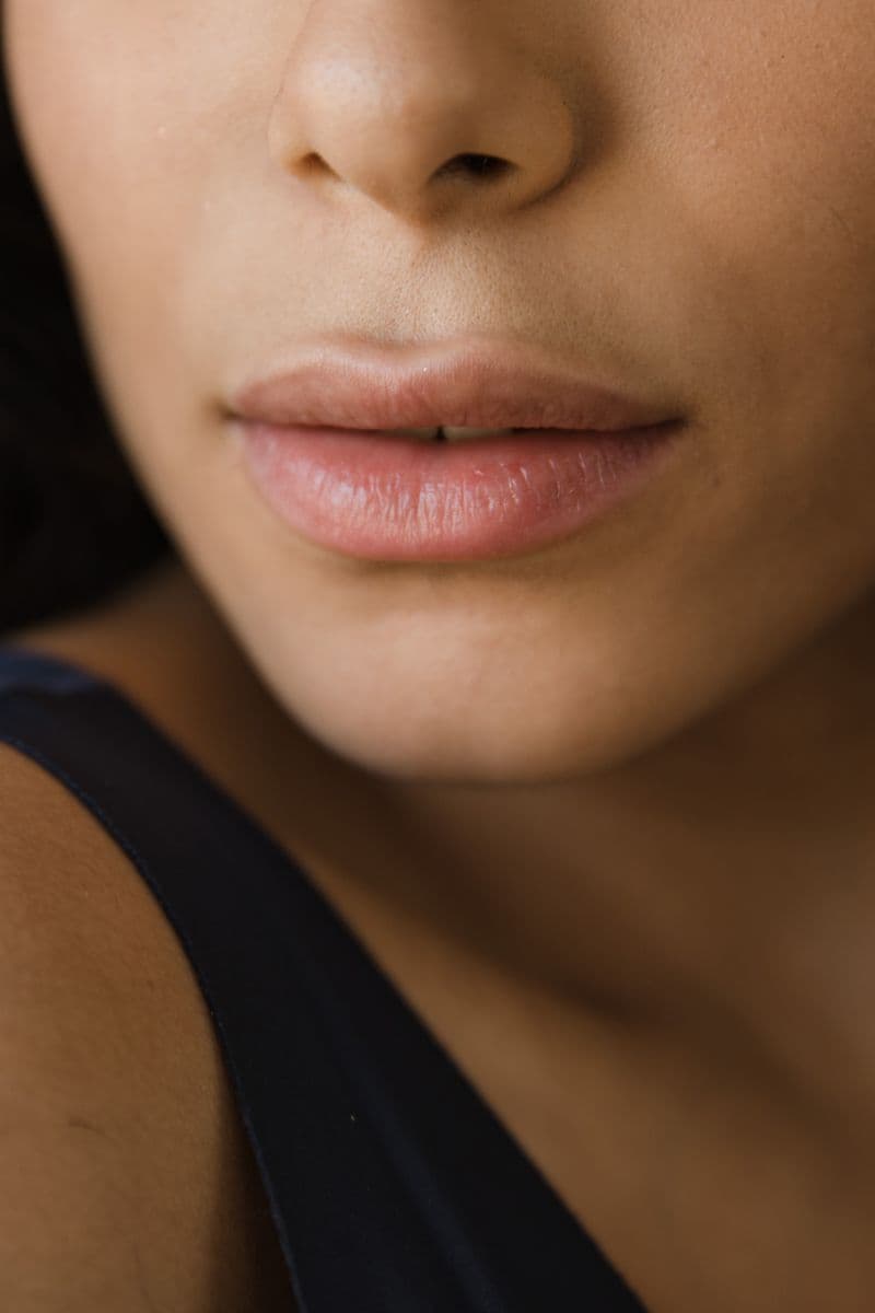 Close-up of woman's lips with smooth healthy skin — lip filler swelling stages day by day guide