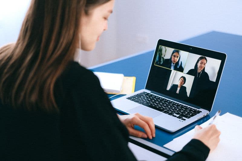 Aesthetic clinic professional using a laptop — choosing the best aftercare software