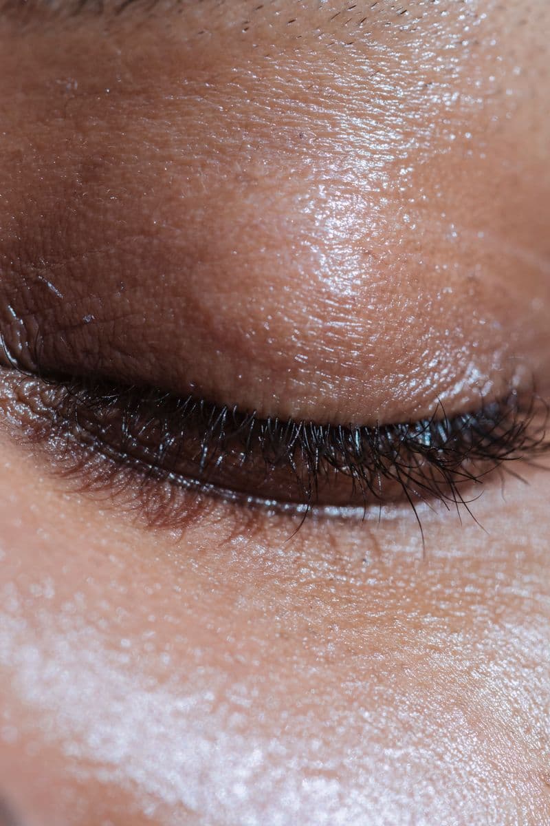 Close-up of glowing skin with long eyelashes — microneedling treatment frequency and schedule guide